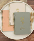 Stylish Aesthetic Spiral Notebook Set Of 3 For Women With Cute College Ruled 8x6 Journals displayed on a wooden table.