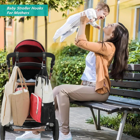 Woman lifting baby beside stroller with 2 Pack Universal Stroller Hooks With Adjustable Carabiner Clips For Diaper Bags And More