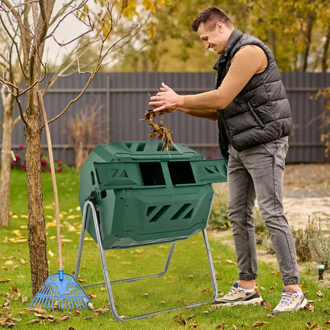 Man using Dual Chamber 43 Gallon Outdoor Compost Tumbler With Sliding Doors And Included Gloves, Rotating Bin For Batch Composting