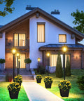 64 Inch Solar Lamp Post With Planter For Garden And Pathway illuminating a modern house entrance with warm white glow