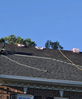 Two roofers using Heavy Duty Roofing Cushion With Killer Traction And Heat Blocking Kneeler Mat on steep shingles.