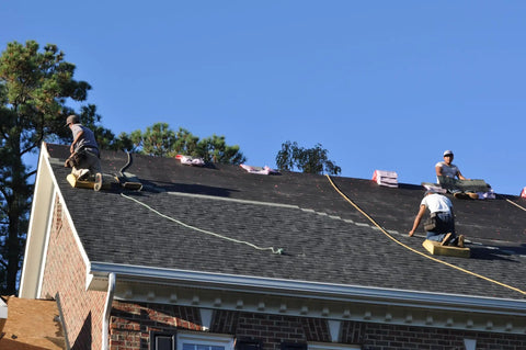 Two roofers using Heavy Duty Roofing Cushion With Killer Traction And Heat Blocking Kneeler Mat on steep shingles.