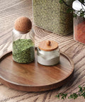 Acacia Wood Lazy Susan Turntable Organizer for Kitchen Cabinets and Pantry with spices on wood countertop, small size.