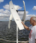 800W Vertical Axis Wind Turbine Kit With MPPT Controller For 12V 24V 48V Systems installed near water, showing curved blade design