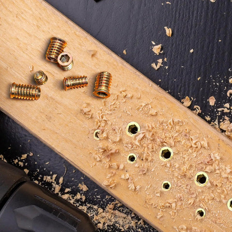 Heavy Duty Carbon Steel Threaded Wood Insert Kit 151 Piece M6 M8 M10 Screw In Set With Hex Wrenches on wooden surface with shavings.