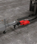 Heavy Duty Universal 2 Inch Forklift Trailer Hitch Adapter With Dead Simple Clamp On Grip For Lightning Fast Pallet Fork Ball Mount Rigging And Zero Fuss Job Site Setup connected to fork at a construction site.