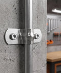 Heavy Duty Stainless Steel Cable Conduit Clamps mounted on a concrete wall, showcasing brushed finish and secure pipe support.