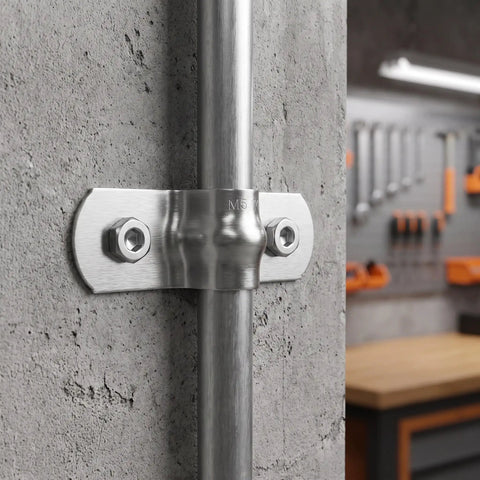 Heavy Duty Stainless Steel Cable Conduit Clamps mounted on a concrete wall, showcasing brushed finish and secure pipe support.