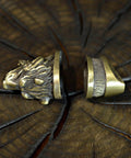 Finger Guard Knife Making Kit With Bolster And Pommel Set, hand cast bronze bear design on wood surface