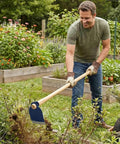 Man using Grub Hoe Head 1.6 Lb Heavy Duty Garden Tool With Four And A Half Inch Blade Width And One And Three Quarter Inch Hole in garden