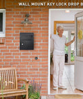 Key Drop Box Wall Mount With Lockable Mail Slot For Cash Deposits mounted on brick wall next to a doorway, black finish