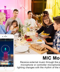 Family dinner with Color Changing LED Strip Lights 100 Feet Bluetooth Remote Music Sync for decor, with mobile app on phone.