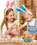Mother and child decorating eggs with 24 Pack Clear Plastic Egg Cartons With 6 Egg Capacity Per Tray on the table