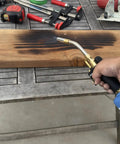 Person using Two 1Lb Empty Propane Tanks for Torch Soldering and Welding, Refillable and Portable, on wooden board