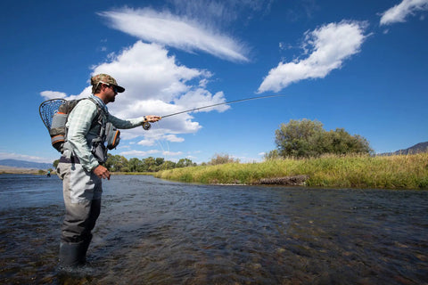 Angler fly fishing with Ridgeline Fly Fishing Backpack For Real Anglers, A Lightweight Tackle Pack With Hydration Pass Through