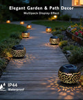 Outdoor Solar Lanterns Waterproof For Porch Garden Patio Vintage Leaf Pattern Metal Lanterns With Warm Flame Light Great Gift For Women Moms Grandmas Perfect For Weddings Yards Camping And More Black along a garden path at night
