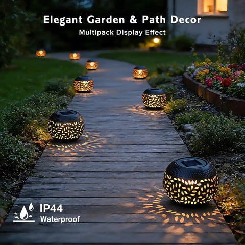 Outdoor Solar Lanterns Waterproof For Porch Garden Patio Vintage Leaf Pattern Metal Lanterns With Warm Flame Light Great Gift For Women Moms Grandmas Perfect For Weddings Yards Camping And More Black along a garden path at night