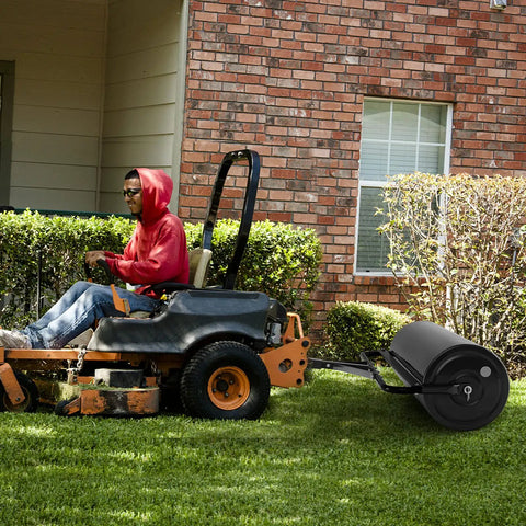 Person towing Tow Behind Lawn Roller With 30 Gallon Water Sand Fill For Tractor Push And Pull, Heavy Duty Rustproof Steel Frame on lawn