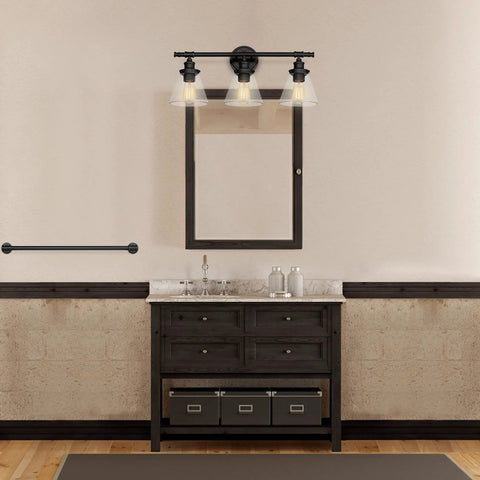 Three-Light Vanity Fixture In Oil Rubbed Bronze With Clear Glass Shades For Over-Mirror Bathroom setup