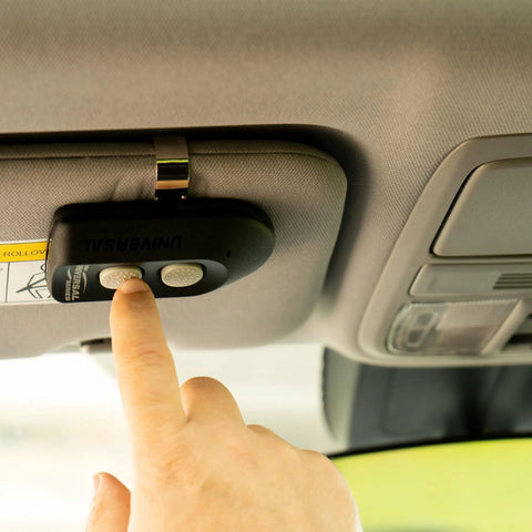 Universal 2 Button Garage Door Opener Remote ACSCTG UNIV2 mounted in car, person pressing button, features visor clip