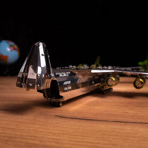 Close-up of Antonov Mriya AN-225 Exclusive Edition Mechanical Model Kit, showcasing wing and engine details on a wooden surface.