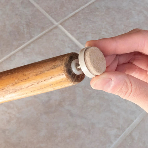 Attaching 1-inch threaded felt furniture glide to chair leg on tile floor, part of 4 pack 1 inch threaded felt furniture glides with one quarter inch adjustable leveling feet for wood tile laminate floors tan includes threaded inserts tough build for heavy use and quiet smooth glide on all floor surfaces.