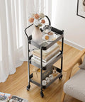 No Tools Needed Foldable Rolling Cart With Three Tiers In Black Metal Finish, Easy Unfold And Lock Setup, Heavy Duty Mobile Storage Organizer On Wheels For Office Garage Tools Kitchen And More shown in living room next to couch.