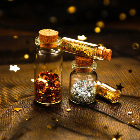 Rad Craft Supply Set Featuring 45 Mini Glass Potion Bottles With Tight Cork Stoppers And Durable Eye Hooks, filled with glitter.