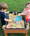 Children playing with Flower Garden Building Toy Set for Toddlers and Preschoolers, a STEM educational activity, in a sandbox.