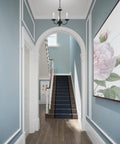 Three Light Black Mini Chandelier With Transitional Steel Design in elegant hallway, blue walls, floral artwork
