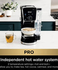 Front view of Hot And Iced Coffee Maker With All In One Dual Brew Pro System with tea cup and oatmeal bowl on counter.