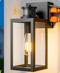 Built Tough Black Motion Sensor Outdoor Wall Light With Dusk Till Dawn Auto Sense And Built In Two Electrical Outlets For Plugging Yard Gear Weatherproof Plug Ready Lighting showing a sleek black design with a motion sensor and dual outlets.