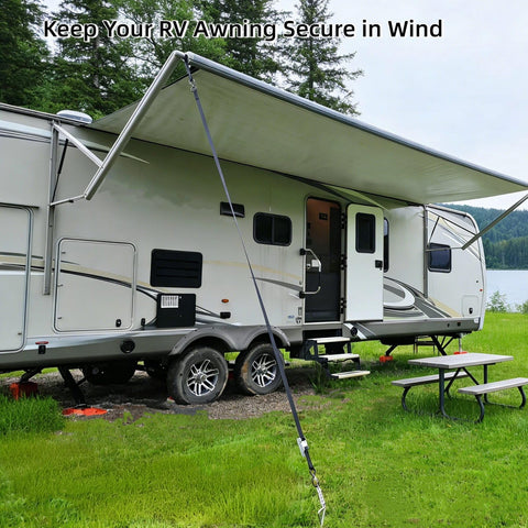 RV Awning Tie Down Kit With Shock Absorbing Springs And 13ft Ratchet Straps securing an awning on a camper in a grassy area