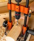 Portable Multi Angle Drill Guide With 60 Degree Adjustable Stand in use on wooden workpiece with shavings