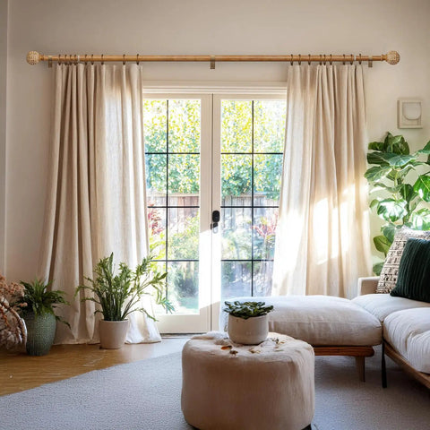 Imitation Wood Grain Leaf Pattern Curtain Rods Set 1 Inch Diameter Adjustable Heavy Duty Boho Drapery Rods For 48 To 84 Inch Windows Natural Wood Finish Finials showing mounted above sliding doors with cream curtains in a living room.