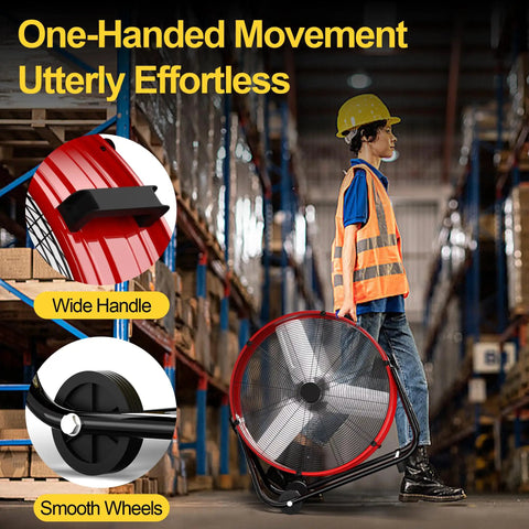Worker moving 14000 CFM Heavy Duty Industrial Drum Fan Built Tough For Real World Jobs through warehouse with smooth wheels and handle.