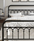 Rock Solid Queen Size Metal Platform Bed Frame With Victorian Scrollwork Headboard Straight Up Classic Look Plus Legit Vintage Charm For Cozy Master Bedrooms Black Finish, close-up view of headboard and bedding.