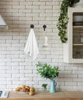 Heavy Duty Retro Flower Wall Hooks Eight Pack Slick Vintage Decorative Hardware Holds Up A Ton, displaying towels and a brush in a kitchen setting.