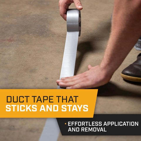 Person applying Heavy Duty Waterproof Duct Tape Grey 30 Yards By 2 Inch 10 Roll Pack No Residue Adhesive on concrete floor