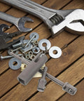Must-Have Stainless Steel Trailer Jack Drill Adapter on a wooden surface with tools and hardware accessories.