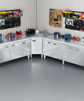 Corner Stainless Steel Prep Table With Cabinet For Work And Storage Heavy Duty Stain Resistant Commercial Kitchen Workstation Outdoor Cabinet With Pull Out Door For Restaurant Hotel Garage And Cafe in a workshop setup.