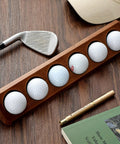 Walnut Wood Golf Ball Display Case 6 Standard Size Wall Mount Holder For Collectors And Golf Fans shown on a wooden surface with golf accessories