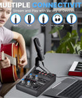 Musician using Five Channel Portable Audio Mixer With USB Interface And Rechargeable Battery Compact DJ Controller.