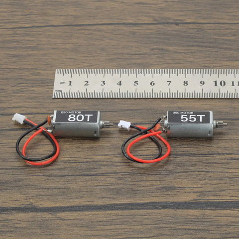 050 Brushed 55T And 80T Motors For One Twenty Fourth SCX24 with ruler for scale, 11T pinion gear visible, upgrade parts