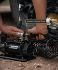 Heavy Duty Portable Air Compressor Tire Inflator Kit Delivers No Sweat Quick Fill With 3.5 Cfm Motor And 12V Plug connecting to tire valve.
