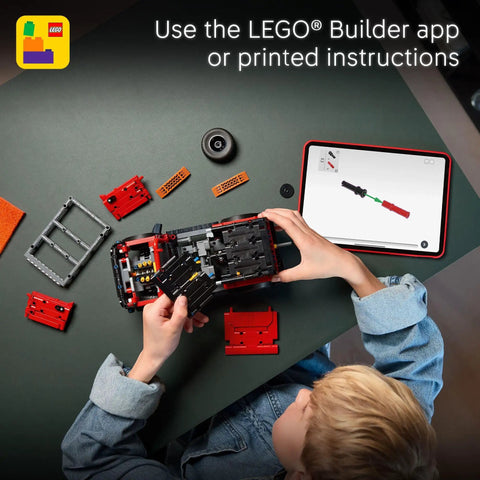 Child assembling Ford Bronco Technic Off Road SUV Building Kit For Kids 9 And Up with tablet instructions on a table