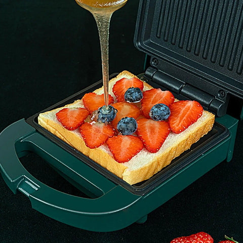 Compact Electric Sandwich Maker And Grill Press For Perfect Grilled Cheese with fruit and honey on bread.
