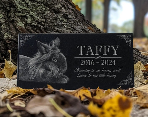 Custom Rabbit Memorial Stone For Outdoor Gardens And Gravesite, black granite with bunny engraving near tree and leaves