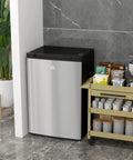 Solid 3 Cubic Foot Compact Upright Freezer With No Fuss Controls And Reversible Door Plays Nice In Tight Apartments Or Busy Kitchens While Keeping Your Frozen Stash Ice Cold In Bright Silver next to storage cart.