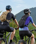 Two cyclists wearing Tactical MOLLE Hydration Pack Backpack With 3L TPU Water Bladder For Cycling Hiking Running Climbing Hunting
